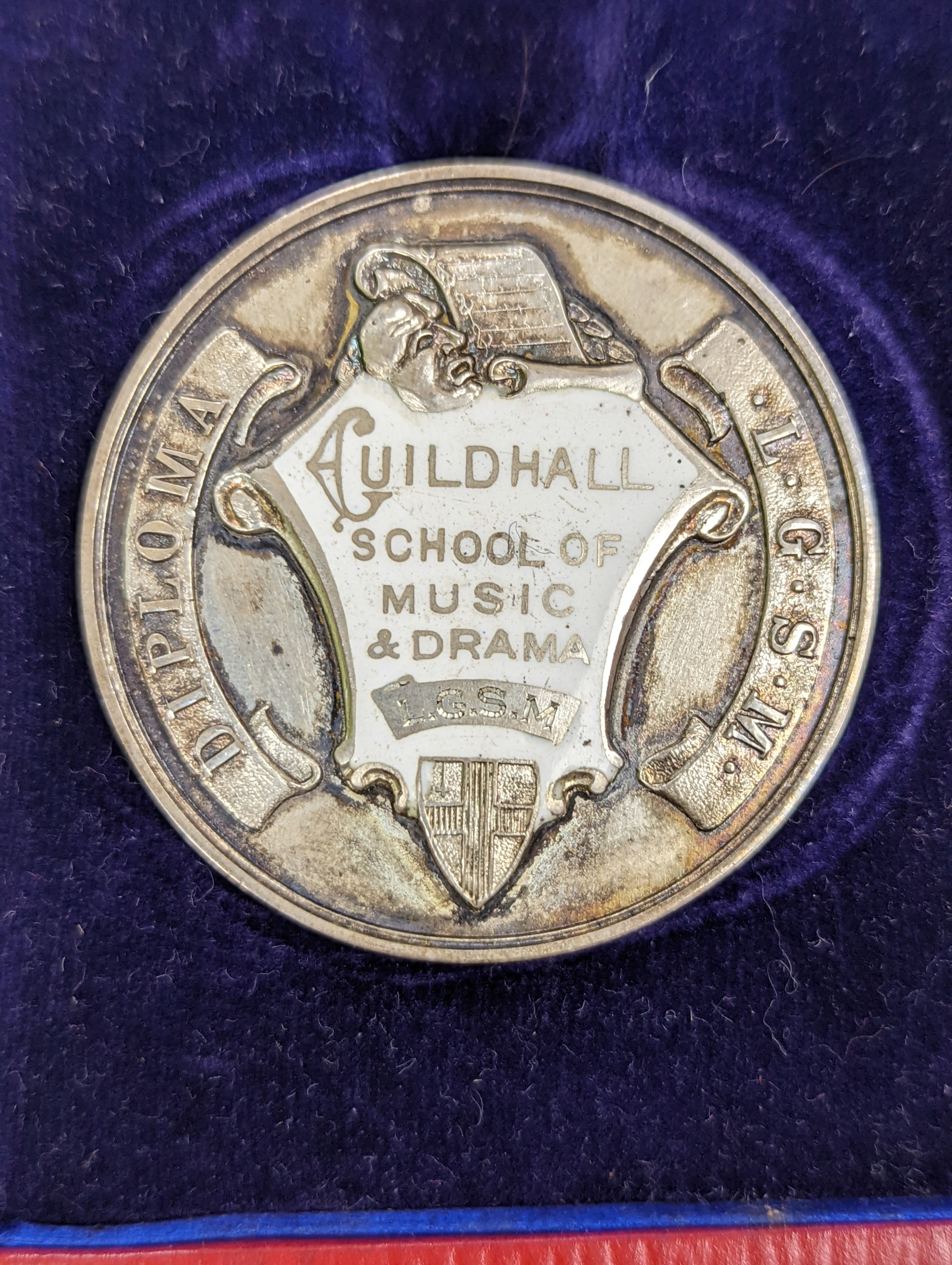 A silver Guildhall School elocution medal, 1935, and a humorous watercolour